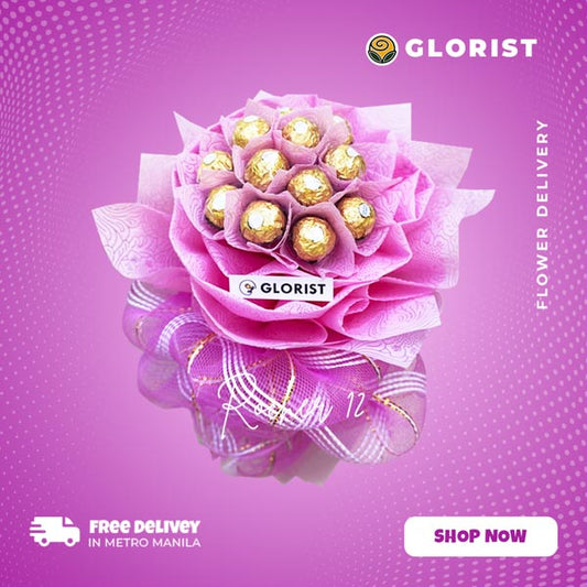 Rocher 12: A luxurious arrangement of 12 exquisite Ferrero Rocher chocolates, meticulously wrapped in light pink tissue and net, creating a delightful indulgence for chocolate lovers.