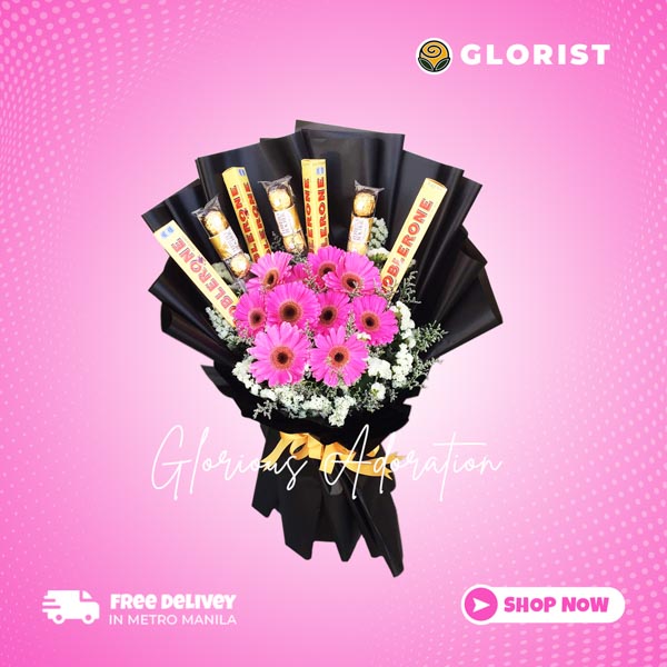 Stunning floral arrangement featuring dark pink gerberas, Toblerone, and Ferrero Rocher chocolates, adorned with statice and misty blue fillers in a Korean wrap. Enhanced with satin ribbon for an elegant touch. Perfect for weddings, special occasions, and gifts.