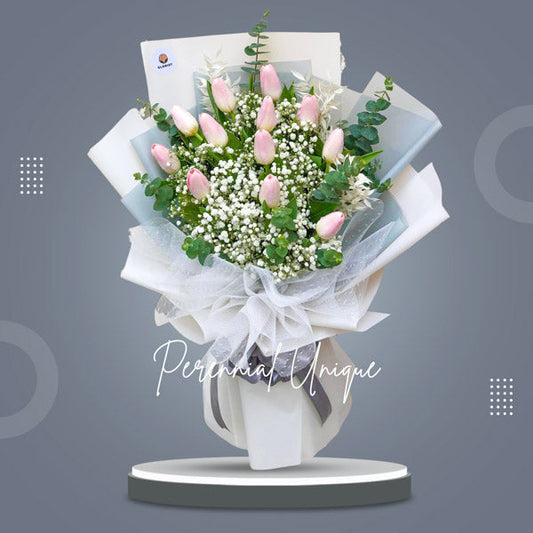 Gorgeous bouquet of one dozen pink tulips with gypsophila and eucalyptus fillers. Tissue and korean wrap adorned with net, exuding natural beauty and charm.