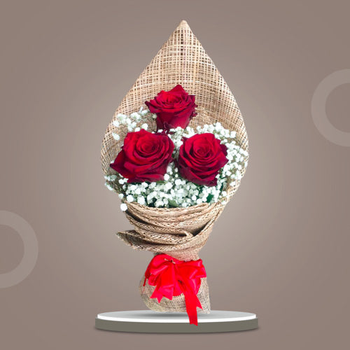 Dreamland Refresh bouquet featuring 5 Red Ecuadorian Roses and Gypsophila fillers wrapped in rustic burlap with a satin ribbon.