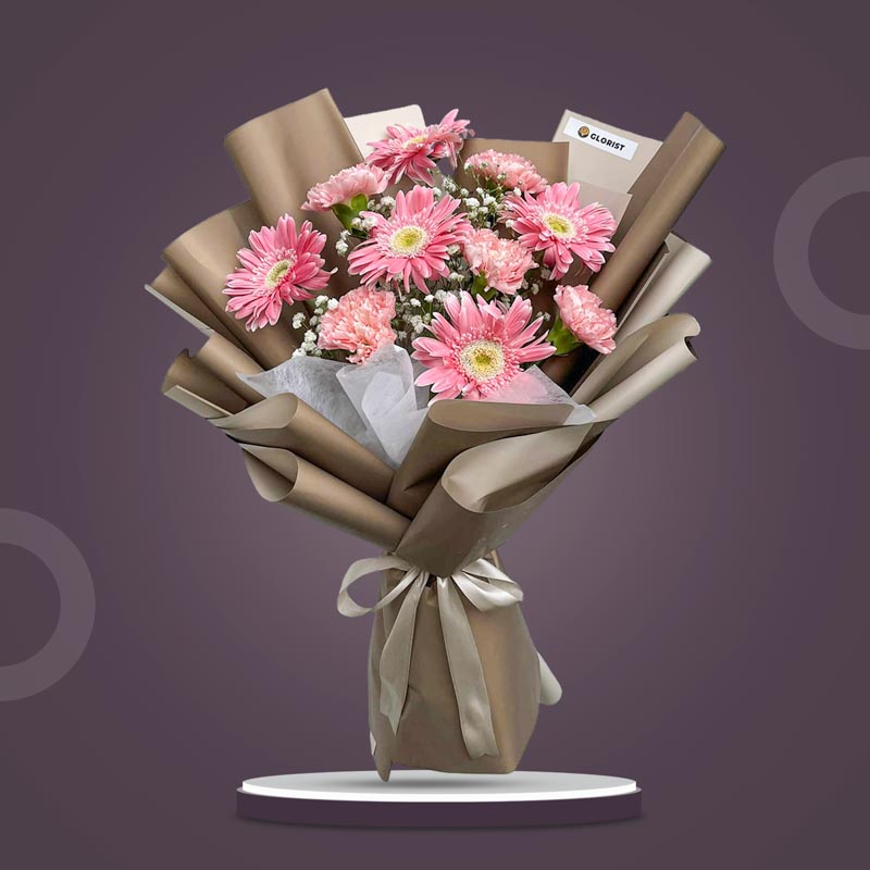 Amber Love bouquet with pink gerberas, carnations, baby’s breath and café wrap with latte ribbon