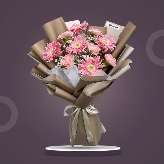 Amber Love bouquet with pink gerberas, carnations, baby’s breath and café wrap with latte ribbon