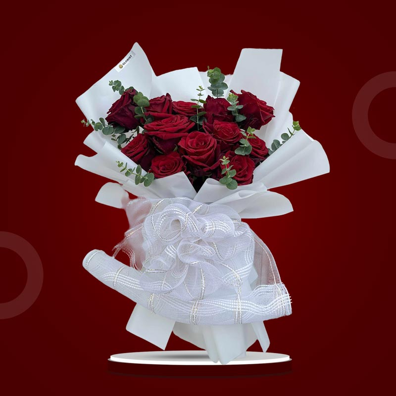 Angelic Dreamland bouquet with 12 red Ecuadorian roses and eucalyptus baby blue wrapped in white paper with mesh net accents
