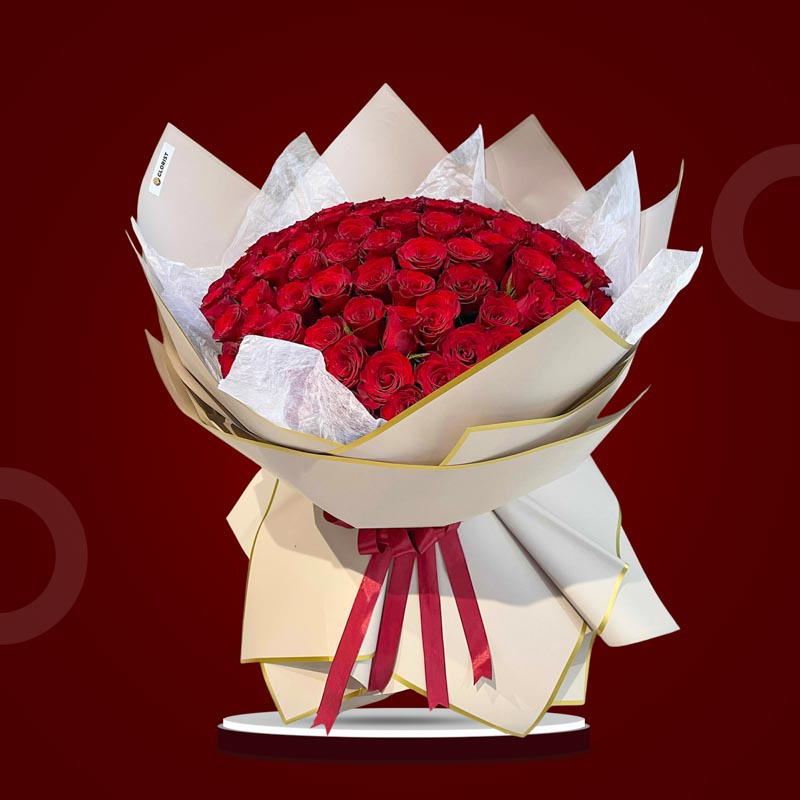Appreciated Flora bouquet with 100 red China roses wrapped in dirty pink bordered Korean paper and tied with a maroon ribbon