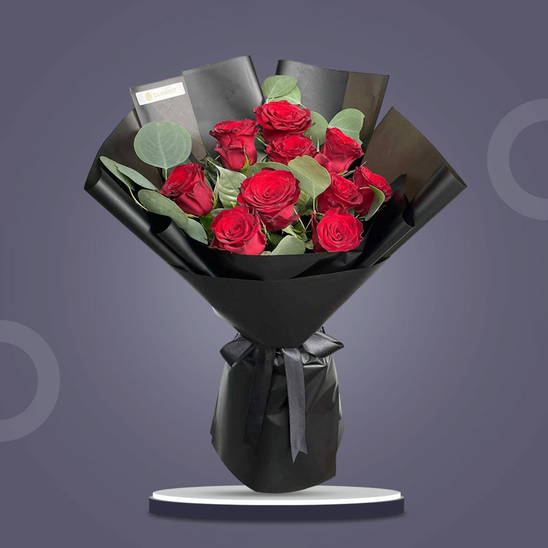 Bloom Flora bouquet with 10 red China roses and eucalyptus silver dollar in black Korean wrap with black ribbon