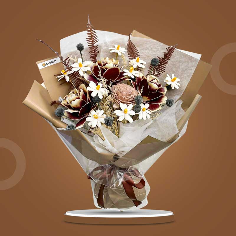 Calcite Timeless dried bouquet with dark maroon Asian peony, black craspedia, sola chrysanthemum, sola daisies, misty filler and skeletal fern in light cafe wrap with brown ribbon