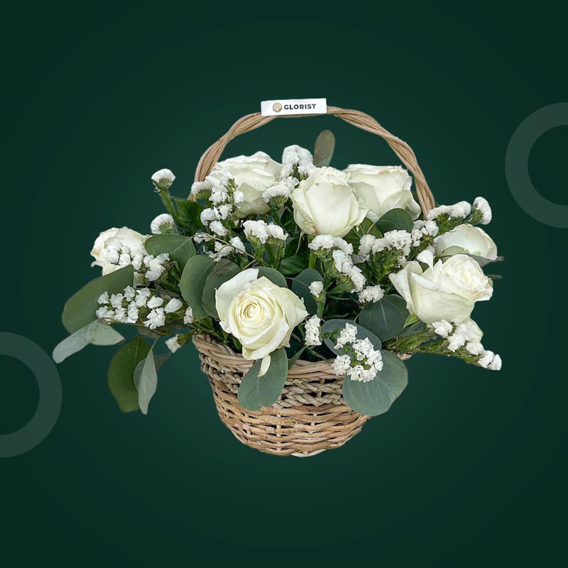 Celeste Fantasy basket with white China roses, silver dollar eucalyptus, and white statice in a wicker basket