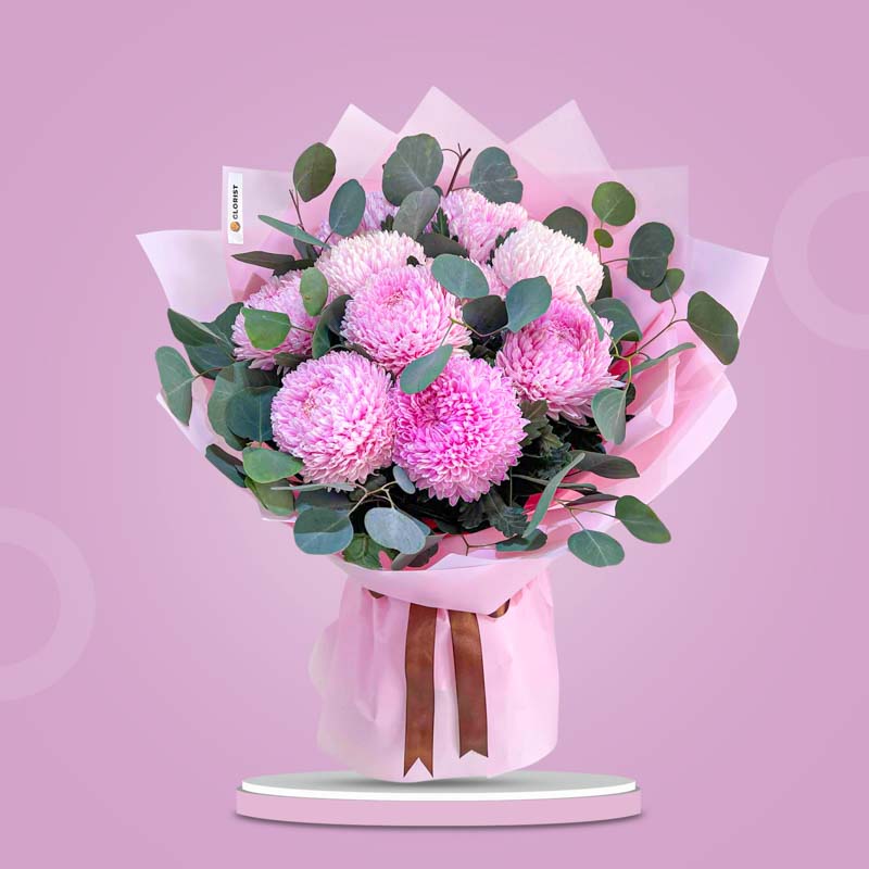 Cheerful Special bouquet with light pink sunlight flowers and silver dollar eucalyptus wrapped in light pink paper with brown ribbon