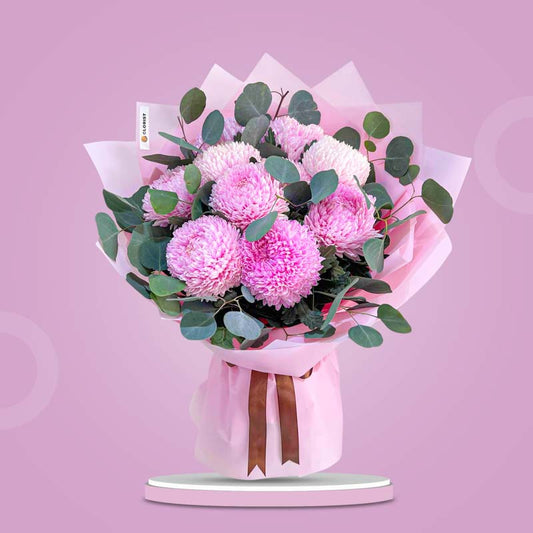 Cheerful Special bouquet with light pink sunlight flowers and silver dollar eucalyptus wrapped in light pink paper with brown ribbon