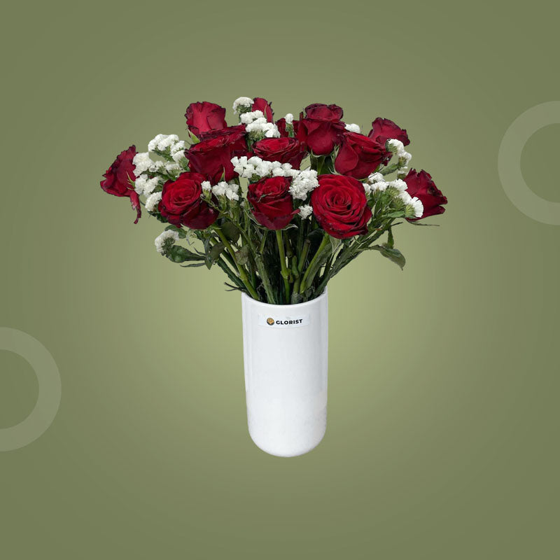 Clever Fresh Flower Vase with fifteen red China roses and two sets of white statice in a clear glass vase