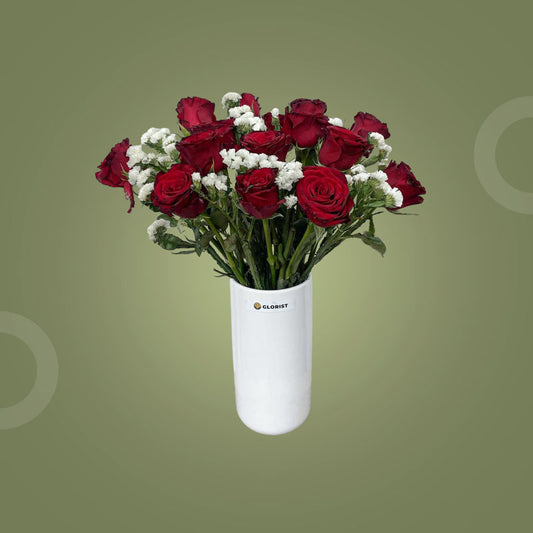 Clever Fresh Flower Vase with fifteen red China roses and two sets of white statice in a clear glass vase