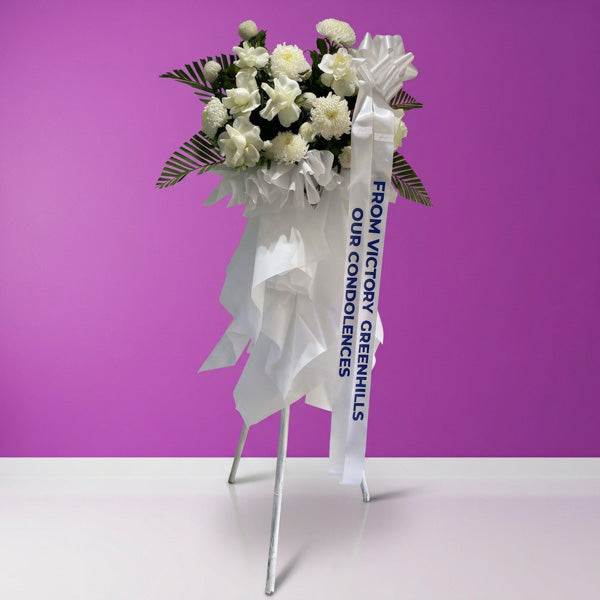 White pompoms and China rose funeral flower stand arrangement
