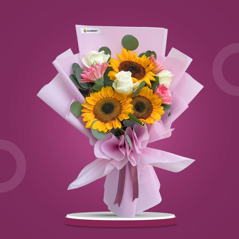 Elegant Love bouquet with sunflowers, white roses, pink gerberas, and eucalyptus in light violet wrap with old rose ribbon