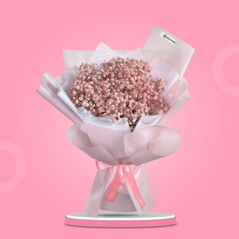 Exciting Snow bouquet with light pink painted Gypsophila Baby’s Breath in light pink and white wrap with pink ribbon