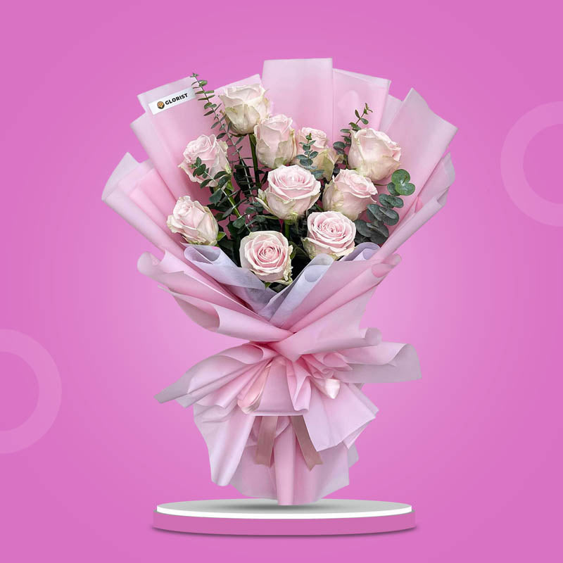 Faithful Flora bouquet with 10 light pink China roses and eucalyptus baby blue in light pink and white wrap tied with a light pink ribbon