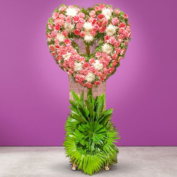 Flame Memory Funeral Stand with chrysanthemums, pink carnations, pink gerbera daisies, white roses, eucalyptus, and anahaw leaves