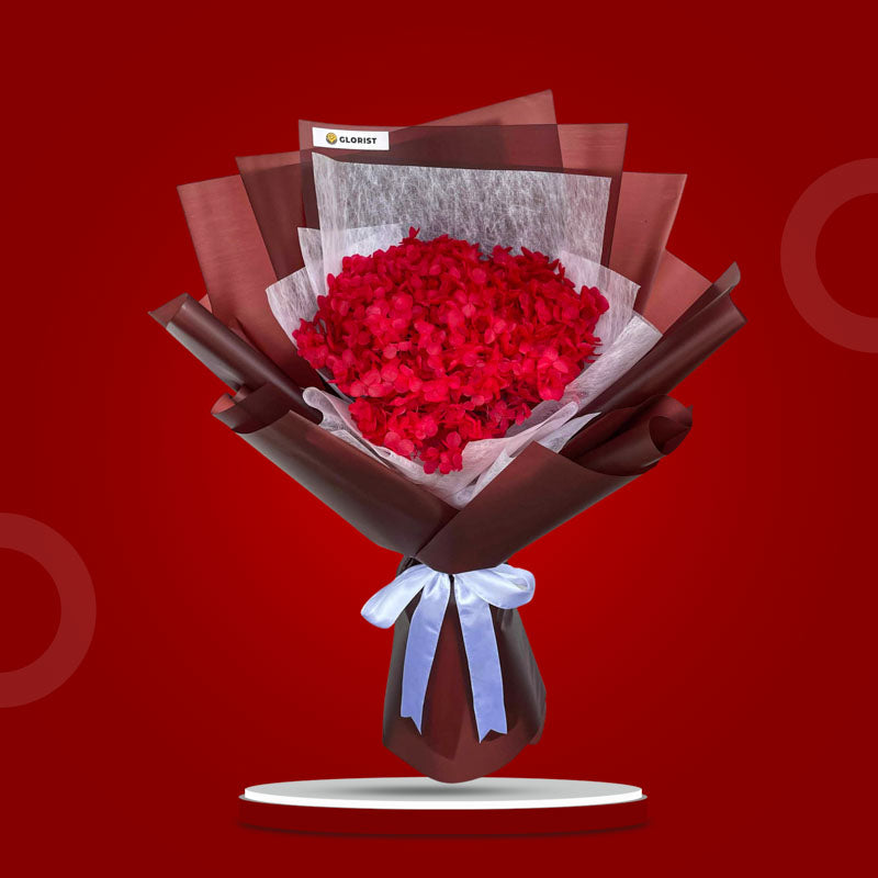 Garnet Timeless dried bouquet with red hydrangea in bergonia red and white non-woven wrap tied with white ribbon