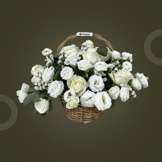 Gleam Fantasy basket with white China roses, lisianthus, white statice, and silver dollar eucalyptus in a wicker basket