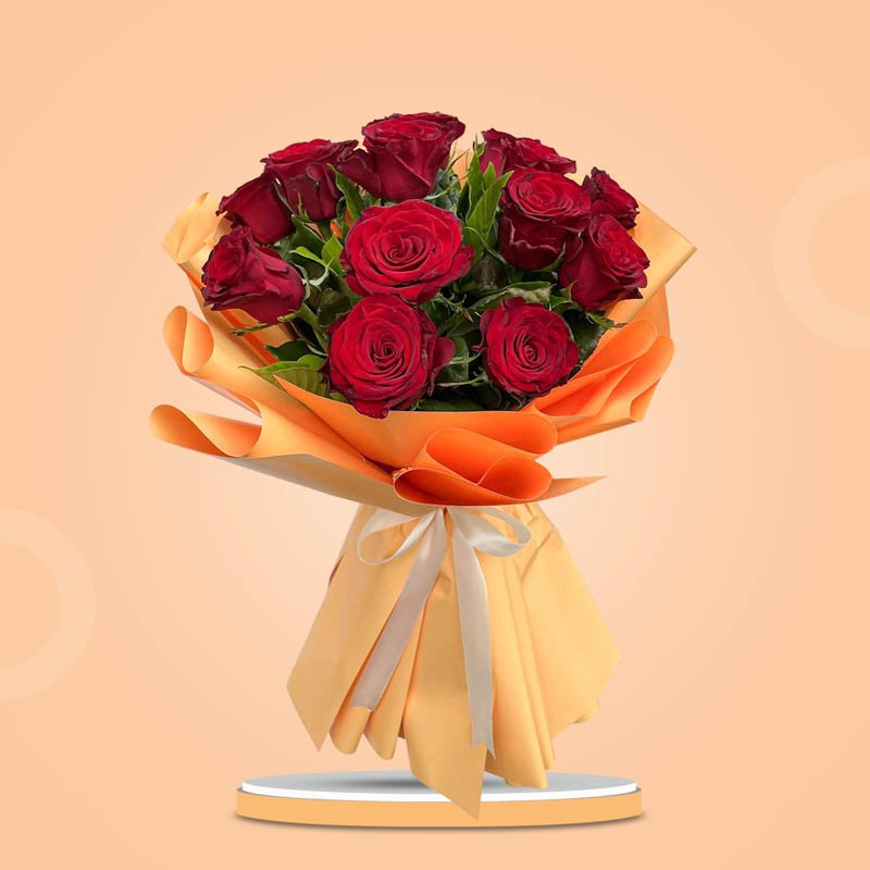 Keen Flora bouquet with 15 red China roses in a yellow-orange wrap tied with a cream ribbon