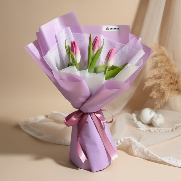 Magnificence Perennial Flower Bouquet with 3 light pink tulips in white non-woven wrap and purple wrapping for flower delivery in Metro Manila