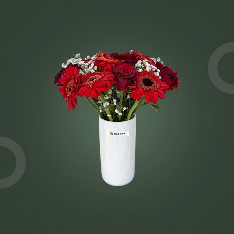 Noteworthy Fresh Flower Vase with ten red China roses, ten red gerbera daisies, and baby’s breath in a clear glass vase