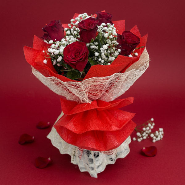 Passion Flora flower bouquet with red China roses, baby’s breath, wrapped in red tissue and burlap