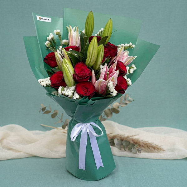 Red rose and stargazer lily bouquet with emerald green Korean-style wrapping