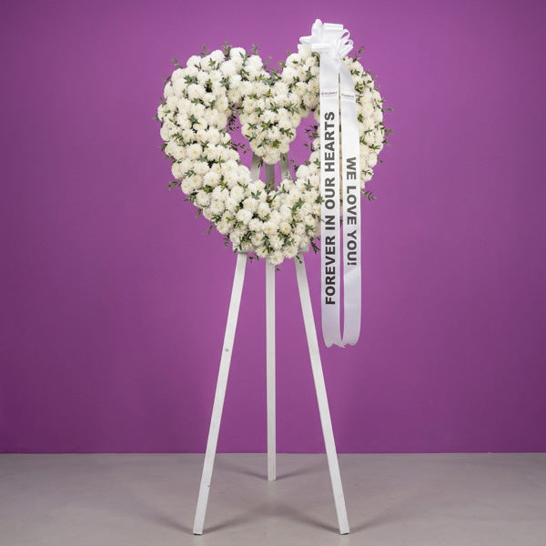 Chrysanthemum funeral flower stand with lush parvi foliage