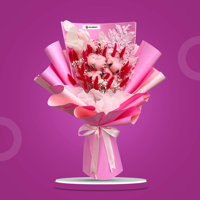 Rhodonite Timeless dried bouquet with dark pink bunny tails, bleached gypsophila, silver dollar, pink cotton heads, and white fern in light pink wrap