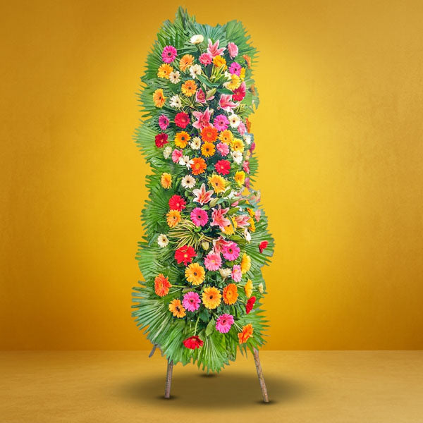 Right Launch Inaugural Stand with stargazer lilies, assorted gerbera daisies, yellow corn leaves, and anahaw leaves