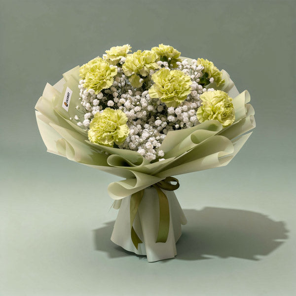 Sacred Radiance bouquet with green carnations and gypsophila baby’s breath in green wrap with olive ribbon — same-day delivery Manila