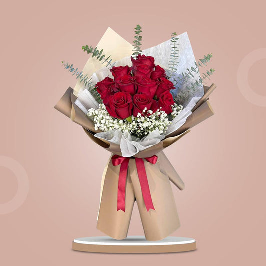 Sharp Dreamland bouquet with 12 red Ecuadorian roses, baby’s breath, and eucalyptus wrapped in light café Korean paper with maroon ribbon