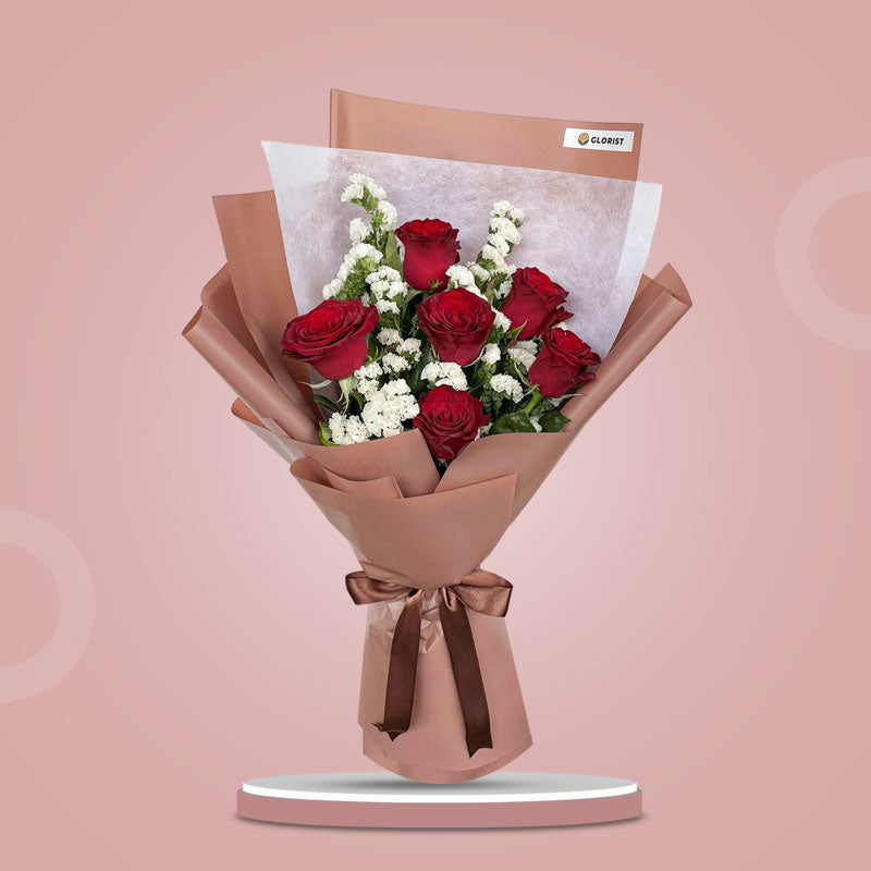 Tender Flora bouquet with 6 red China roses and white statice in bean brown and white wrap with brown ribbon