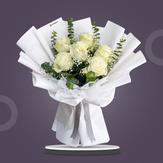 Truthful Dreamland bouquet with white Ecuadorian roses, baby’s breath, and eucalyptus in white Korean wrap and non-woven wrap tied with gray ribbon