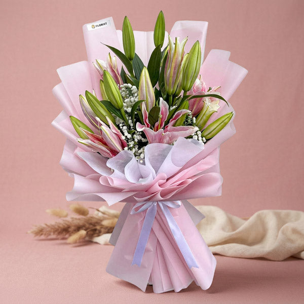 Unfazed Breeze bouquet with 5 stem Stargazer lilies and gypsophila in light pink and white wrap with white ribbon