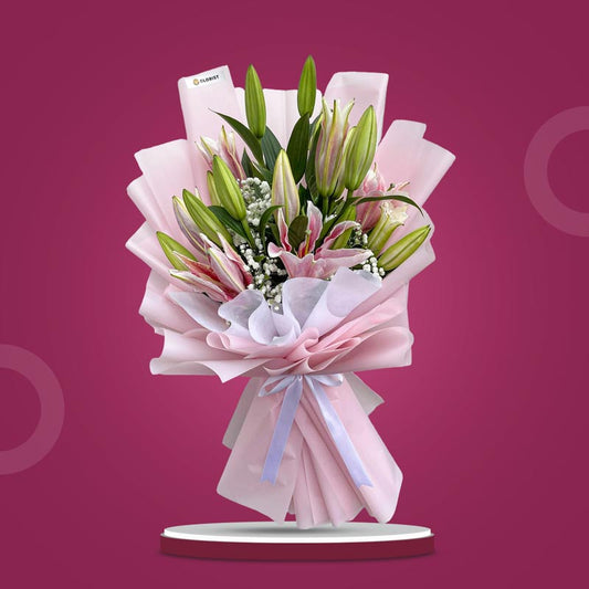 Unfazed Breeze bouquet with 5 stem Stargazer lilies and gypsophila in light pink and white wrap with white ribbon