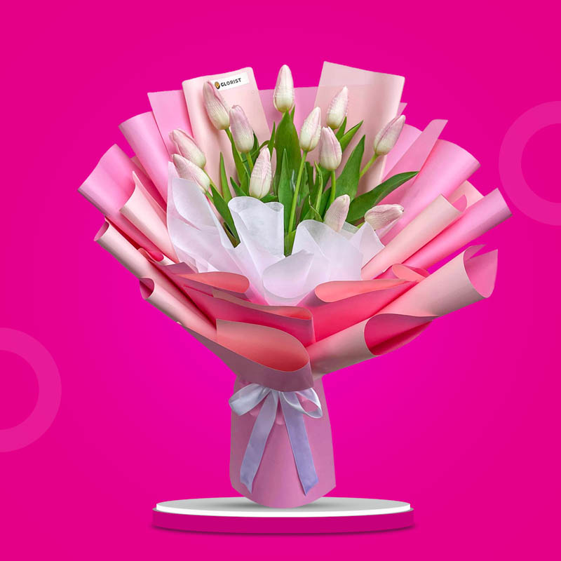 Versatile Perennial bouquet with twelve light pink tulips in two-toned pink Korean wrap tied with a white ribbon