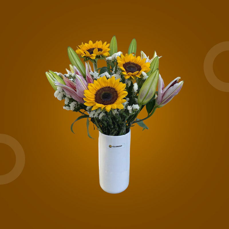 Vibrant Fresh Flower Vase with three stargazer lilies, three sunflowers, and white statice in a clear glass vase