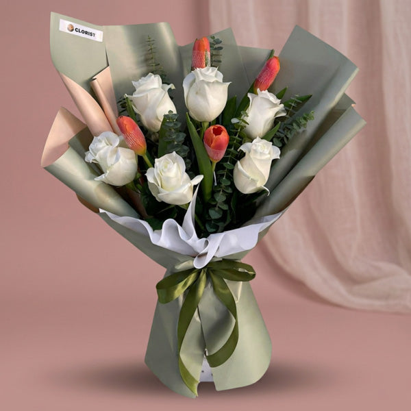 White imported roses and orange tulips bouquet with eucalyptus fillers
