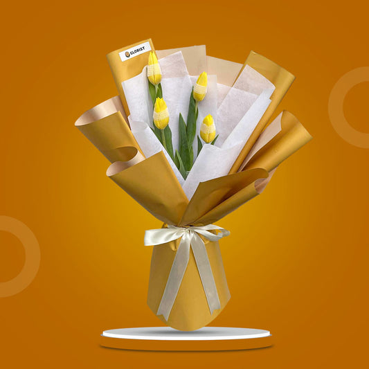 Worthy Perennial bouquet with four yellow tulips in mustard and white wraps tied with a cream ribbon