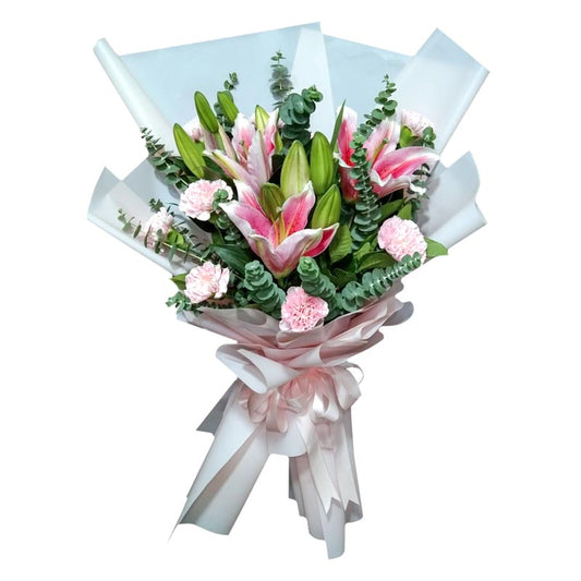 A stunning bouquet featuring three beautiful Stargazer lilies and a dozen vibrant carnations, complemented by fresh and fragrant eucalyptus leaves. This exquisite arrangement is expertly wrapped in a Korean-style wrap, adorned with a luxurious satin ribbon. Celebrate any occasion with this enchanting bouquet of flowers, designed to impress and delight.