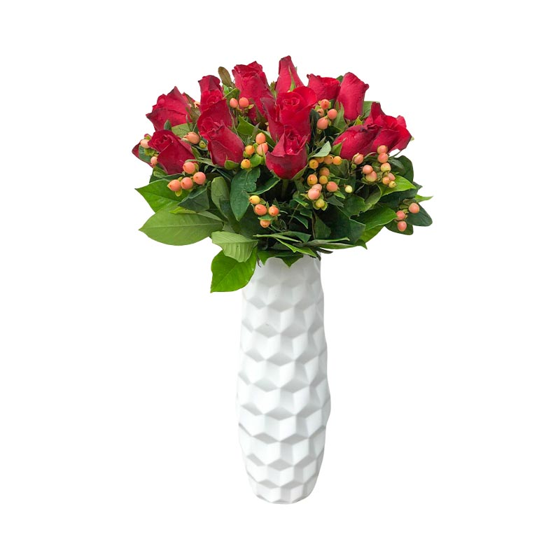 Certain vase arrangement showcasing 24 vibrant red Baguio roses and luscious berries, beautifully arranged in a sleek white plastic vase. A stunning composition of freshness and elegance.