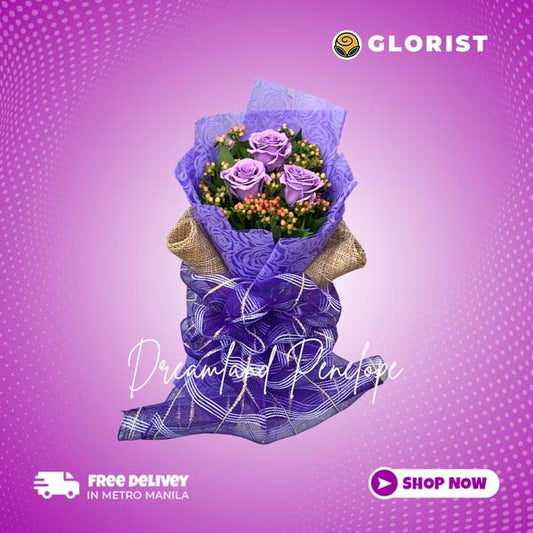 A bouquet of Three Floral Painted Purple Ecuadorian roses with hypericum berries fillers, beautifully wrapped in purple tissue and burlap wrap with purple net