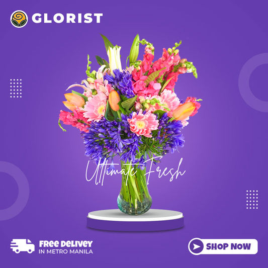 Exquisite vase flower arrangement showcasing the beauty of Stargazer lilies, light pink gerberas, and tulips, accentuated by delicate agapanthus fillers.