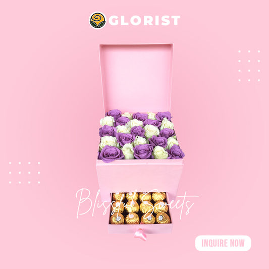 Elegant box filled with a combination of white roses and beautifully painted purple roses, accompanied by indulgent Ferrero Rocher chocolates.