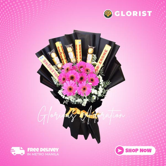 Stunning floral arrangement featuring 10 dark pink gerberas, 4 Toblerone, and 3 3-piece Ferrero Rocher chocolates, adorned with statice and misty blue fillers in a black Korean wrap. Enhanced with gold satin ribbon for an elegant touch. Perfect for weddings, special occasions, and gifts.