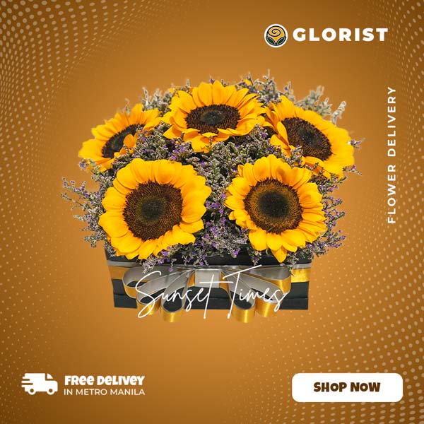 A charming box arrangement featuring 6 vibrant Sunflowers accompanied by delicate Misty Blue Fillers. The flowers are thoughtfully arranged in a stylish box, adorned with a luxurious Satin Ribbon, creating an elegant and captivating display.