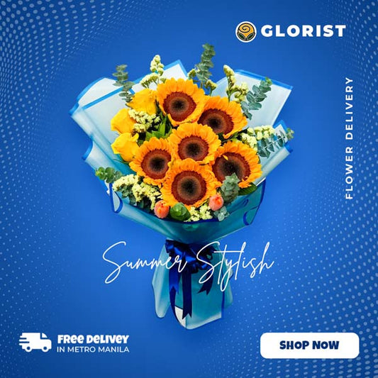 An exquisite bouquet showcasing the vibrant beauty of Sunflowers, Ecuadorian Roses, and Tulips, accentuated with Statice and Eucalyptus Fillers. The bouquet is expertly arranged in a Korean Striped Wrap, adding a touch of uniqueness, and adorned with a luxurious Satin Ribbon, creating a stunning visual appeal.