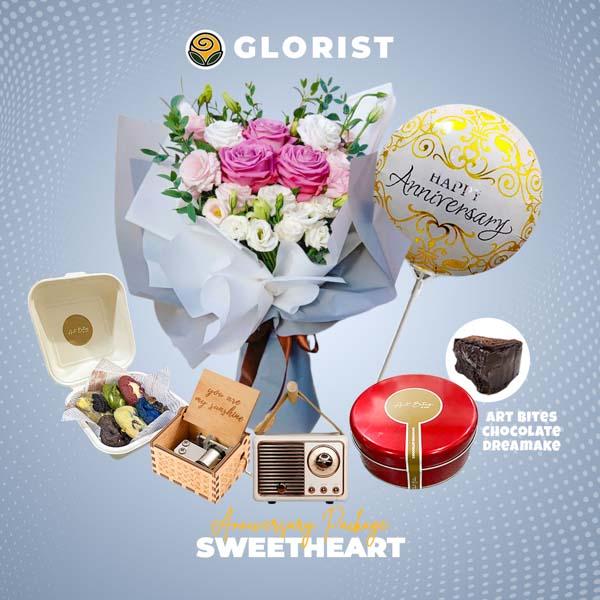 Enchanting package featuring a vibrant Ecuadorain rose and lisianthus bouquet, a decadent Art Bites chocolate dream cake wiht its cookies, a delightful music box, a mesmerizing 3D lamp, and a celebratory anniversary balloon.