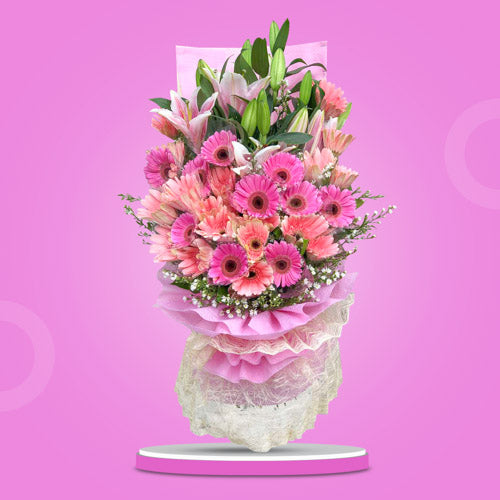 Vibrant bouquet with dark and light pink gerberas, stargazers, and aster fillers, wrapped in tissue and abaca. Ideal for special occasions. Flower delivery in Mandaluyong, Paranaque, Tagaytay, and Bulacan.